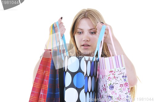 Image of happy young adult women  shopping with colored bags