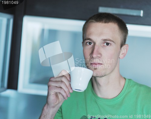 Image of handsome young man drink fresh morning coffee