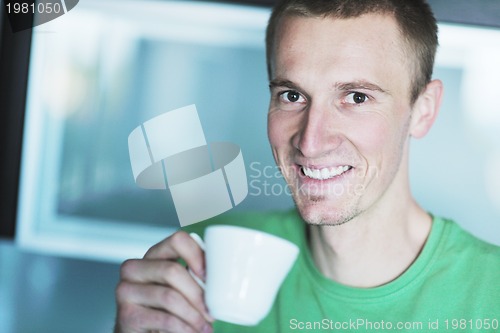 Image of handsome young man drink fresh morning coffee