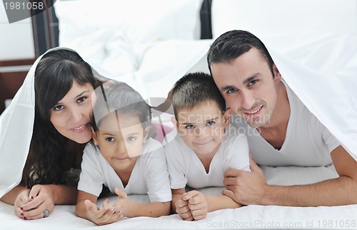 Image of happy young Family in their bedroom