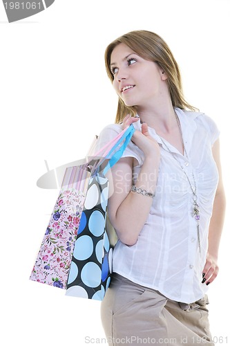 Image of happy young adult women  shopping with colored bags