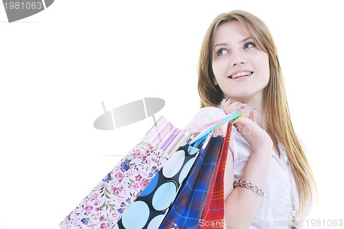 Image of happy young adult women  shopping with colored bags