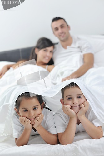 Image of happy young Family in their bedroom