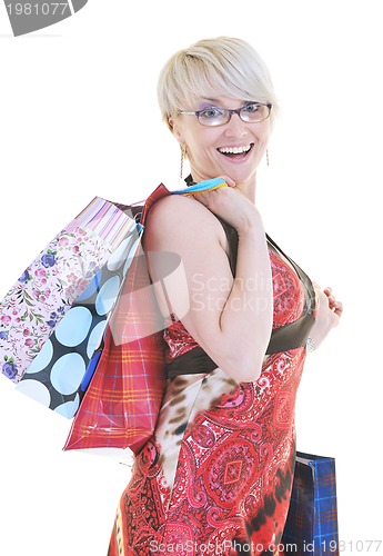 Image of happy young adult women  shopping with colored bags