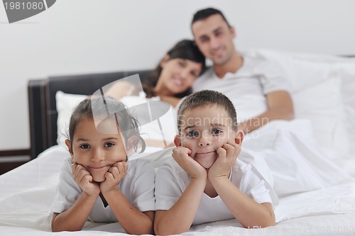 Image of happy young Family in their bedroom
