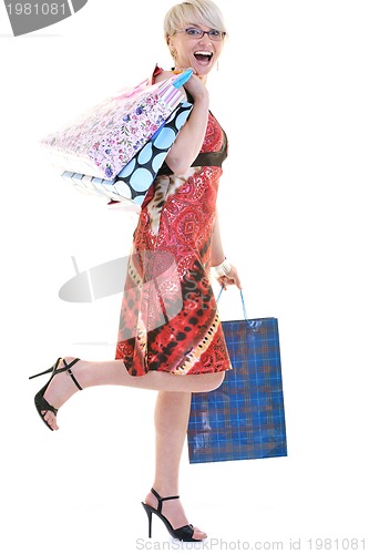 Image of happy young adult women  shopping with colored bags