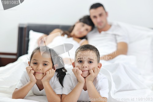 Image of happy young Family in their bedroom