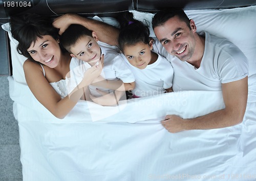 Image of happy young Family in their bedroom