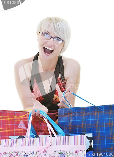 Image of happy young adult women  shopping with colored bags