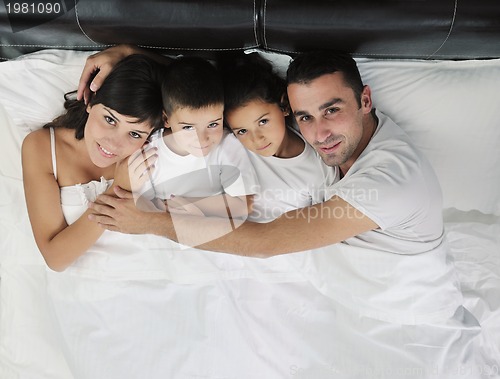 Image of happy young Family in their bedroom