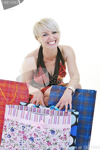 Image of happy young adult women  shopping with colored bags