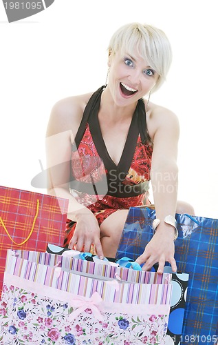 Image of happy young adult women  shopping with colored bags