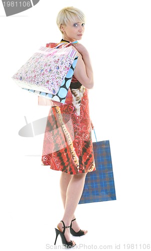 Image of happy young adult women  shopping with colored bags
