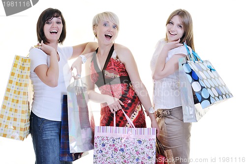 Image of happy young adult women  shopping with colored bags