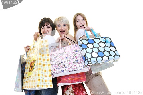 Image of happy young adult women  shopping with colored bags