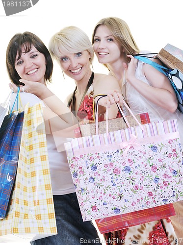 Image of happy young adult women  shopping with colored bags