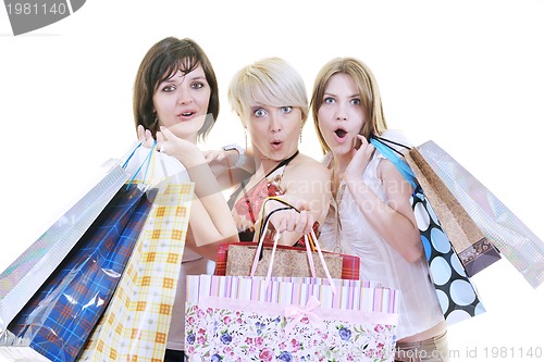 Image of happy young adult women  shopping with colored bags