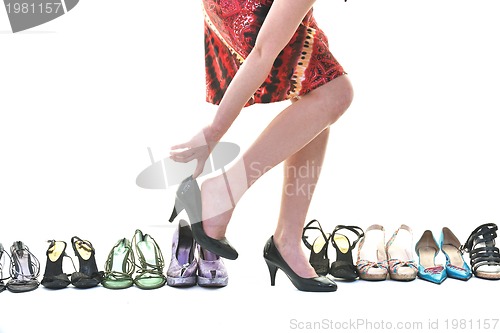 Image of pretty young woman with buying shoes addiction, isolated on whit