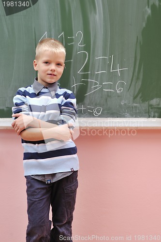 Image of happy young boy at first grade math classes 