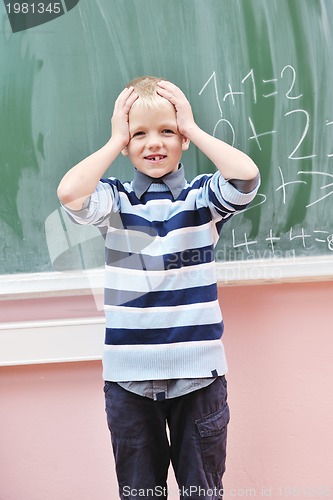 Image of happy young boy at first grade math classes 