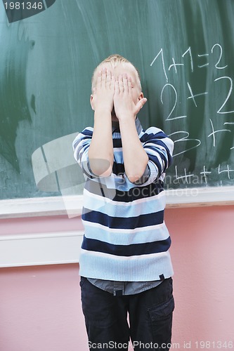 Image of happy young boy at first grade math classes 