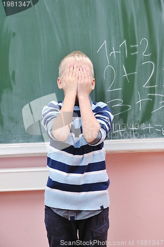 Image of happy young boy at first grade math classes 