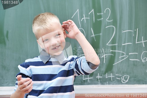 Image of happy young boy at first grade math classes 