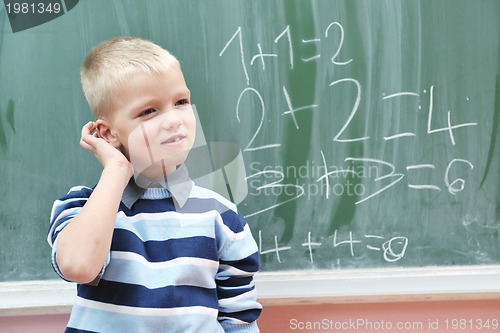 Image of happy young boy at first grade math classes 