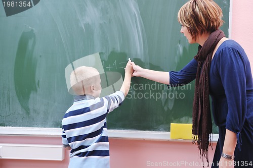 Image of happy young boy at first grade math classes 