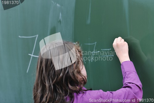 Image of happy school girl on math classes