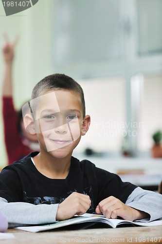 Image of happy young boy at first grade math classes 