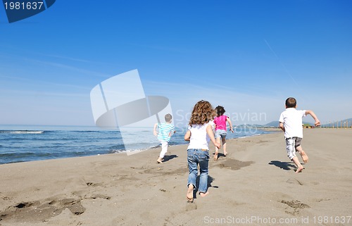 Image of happy child group playing  on beach