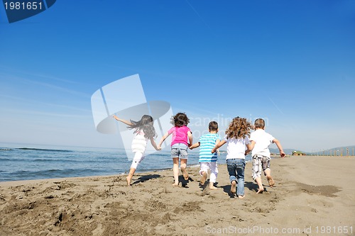 Image of happy child group playing  on beach