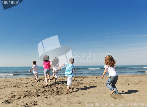Image of happy child group playing  on beach