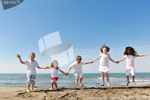Image of happy child group playing  on beach