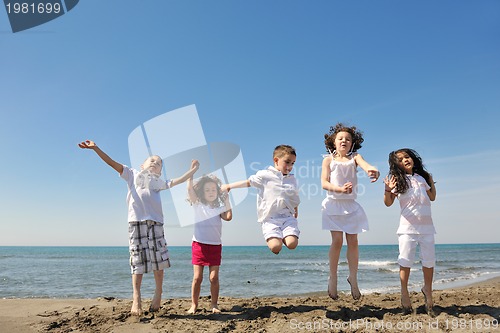 Image of happy child group playing  on beach