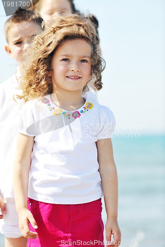 Image of happy child group playing  on beach