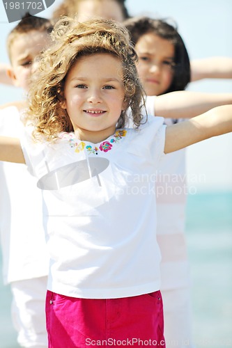 Image of happy child group playing  on beach