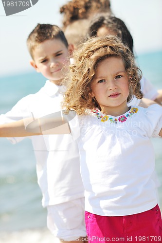 Image of happy child group playing  on beach