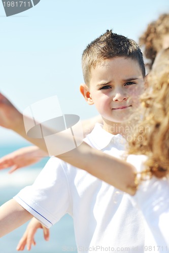 Image of happy child group playing  on beach