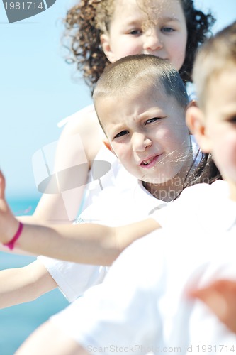 Image of happy child group playing  on beach