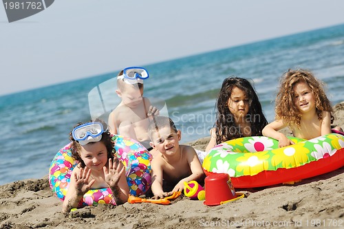 Image of child group have fun and play with beach toys