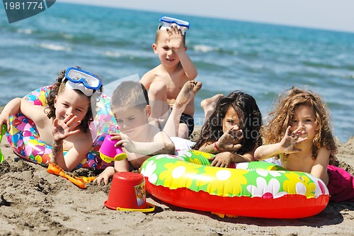 Image of child group have fun and play with beach toys