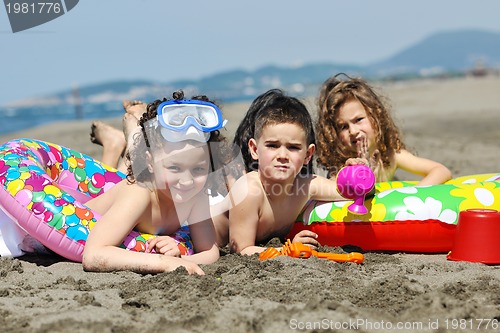Image of child group have fun and play with beach toys