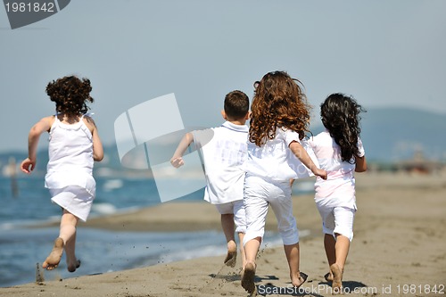 Image of happy child group playing  on beach