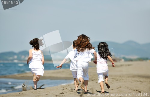 Image of happy child group playing  on beach