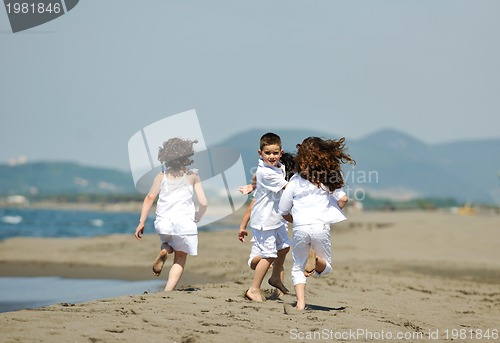 Image of happy child group playing  on beach