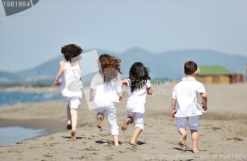 Image of happy child group playing  on beach