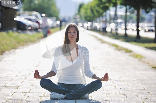 Image of yoga at sunny street