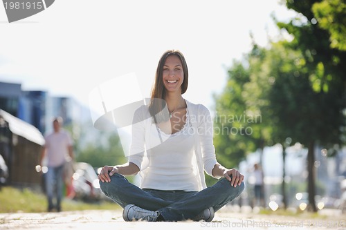 Image of yoga at sunny street